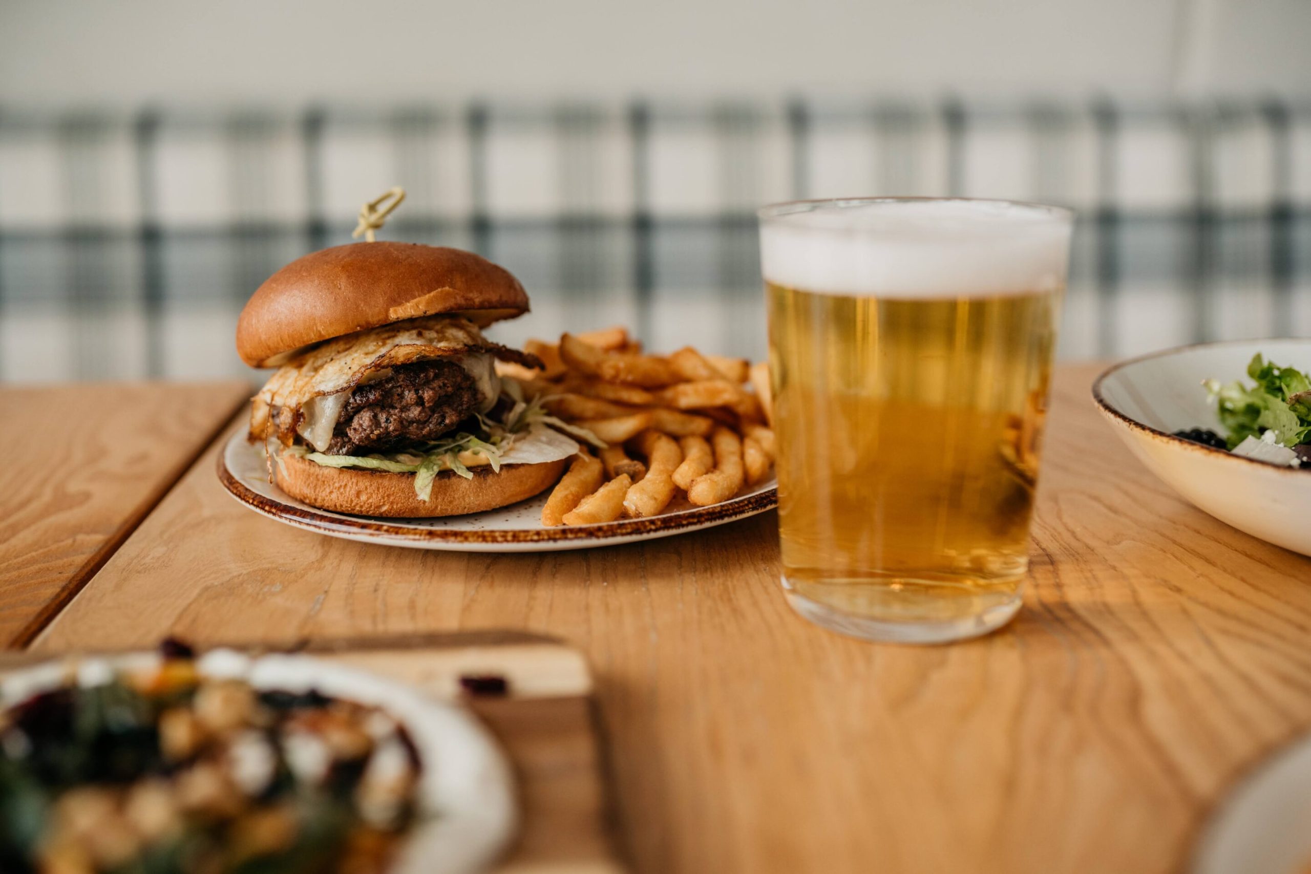 Elk Burger Elk Burger with a fried egg, pepper jack, lettuce, onion, kimchi aioli, and fries