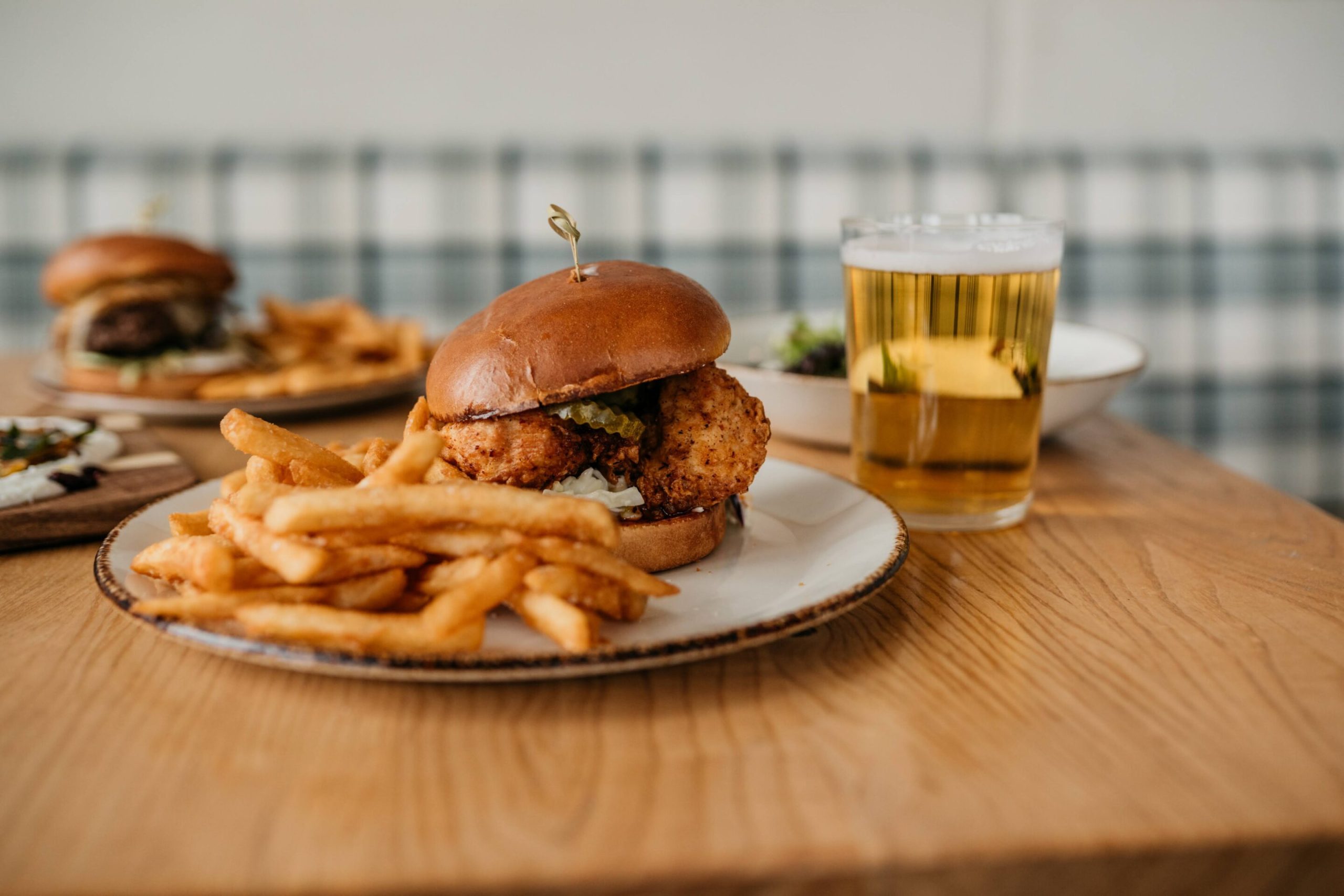 Birdsong Hot Chicken Birdsong Hot Chicken with fried chicken tossed in bird's eye chili sauce, creamy slaw, sweet pickles, brioche bun, fries