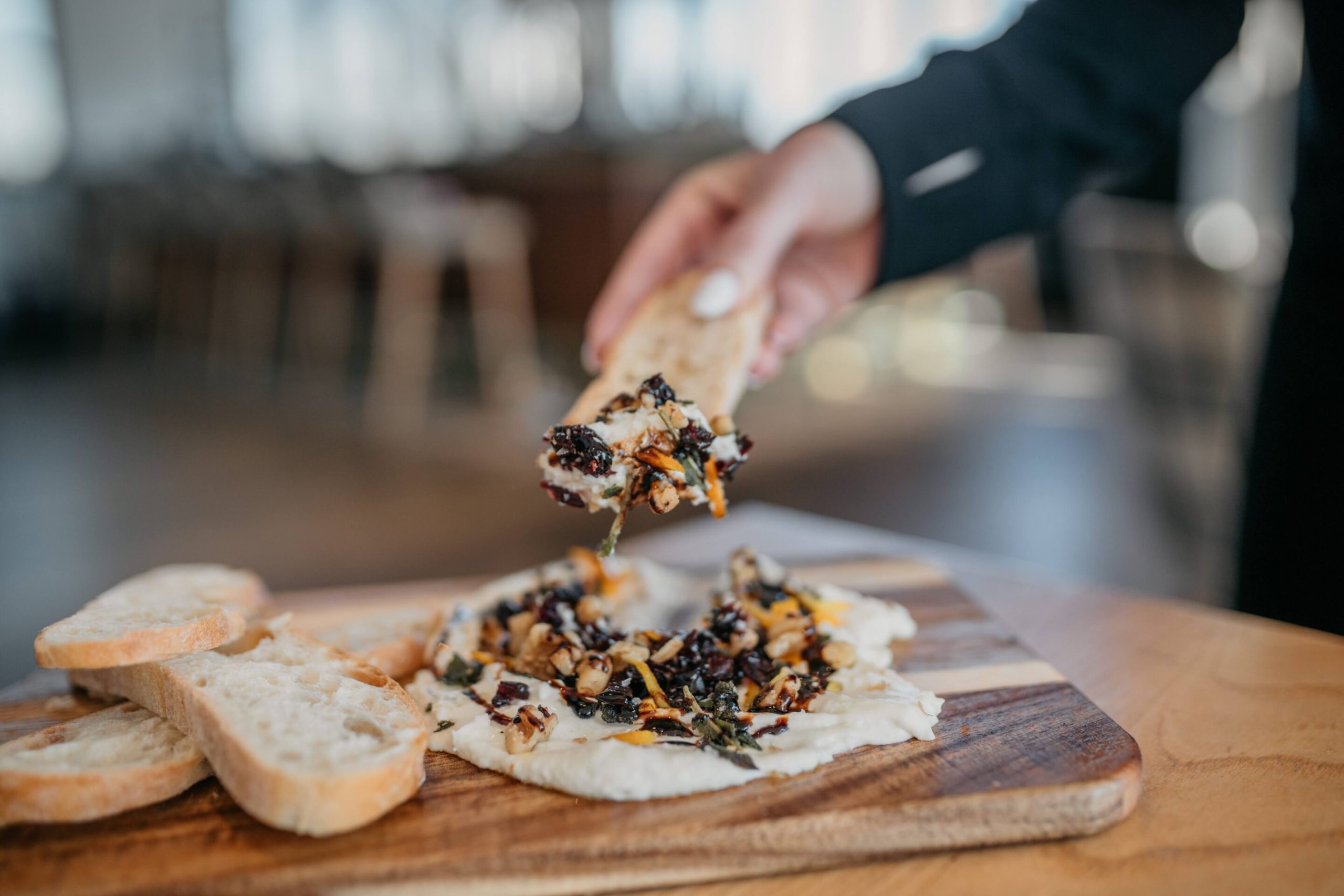 Ricotta Board Ricotta Board with buttermilk ricotta, candied orange zest, crispy sage, cranberries, walnuts, evoo, balsamic glaze, focaccia crisps